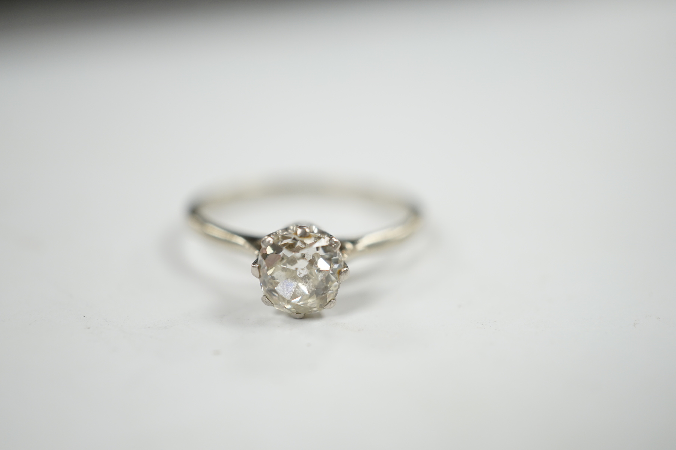 A white metal and solitaire diamond set ring, size Q, gross weight 2.1 grams